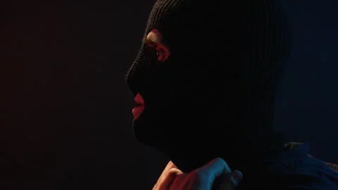 Man puts on balaclava, prepares to rob bank Stock Footage 312475452