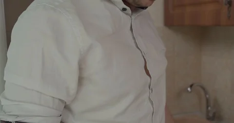 Man puts on a bar apron Stock Footage 130051304