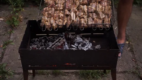Man puts barbecue on coal Stock Footage 111748581