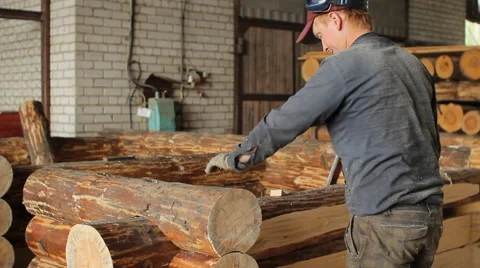 A man puts a beam with a hammer Stock Footage 65314842