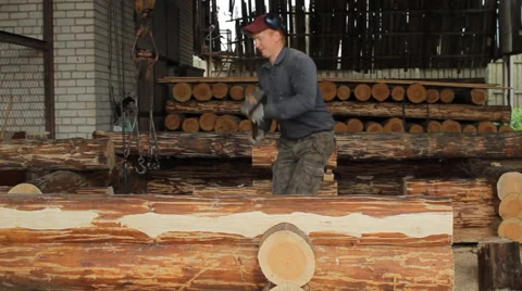 A man puts a beam with a hammer Stock Footage 65414401