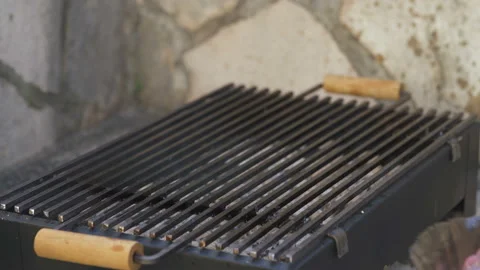 Man puts beef steaks on the grill Stock Footage 122611717