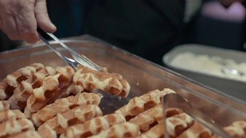 A man puts a Belgian waffle on his plate Video stock 220449938