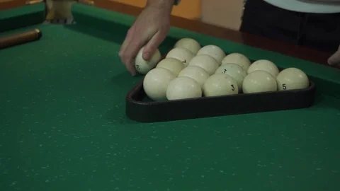 A man puts billiard balls Stock Footage 103117745