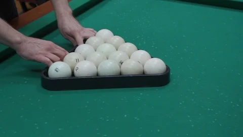 A man puts billiard balls Stock Footage 103118889