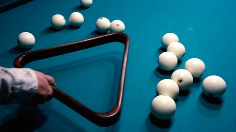 Man puts billiard balls in shape Stock Footage 95998352