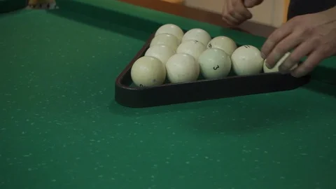Man puts billiard balls in a triangular pyramid Stock Footage 103117545