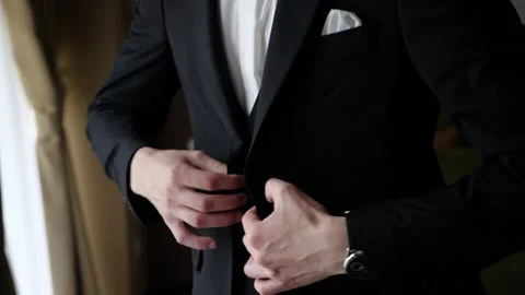 The man puts on a black jacket Stock Footage 268190506