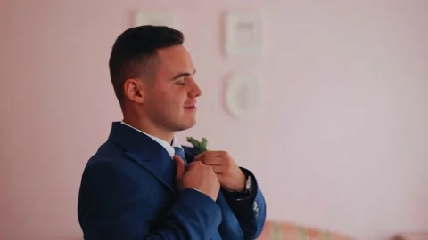 The man puts on a blue jacket. Side shot of a guy who dresses for a meeting Stock Footage 182150744
