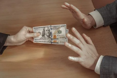 Man puts both hands forward and refuses to take dollars as a bribe. Corrupt.. Foto stock