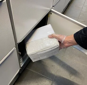 Man puts a box in parcel machine on the street Stock Photos