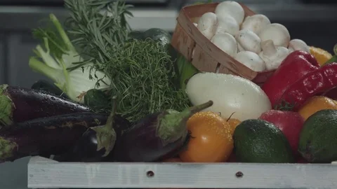 Man puts a box of vegetables and greens on the table 스톡 동영상 80802383