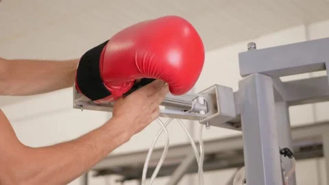 Man puts boxing glove on robot's mechanical arm. Stock Footage 204970528