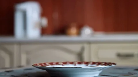 Man puts the bread on a plate close up Stock Footage 71289440