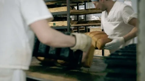 Man puts the bread on the table Stock Footage 76874961