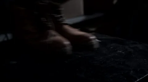 The man puts brown shoes on the table. Stock Footage 62559924