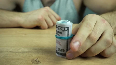 A man puts a bundle of money on the table Stock Footage 144598169