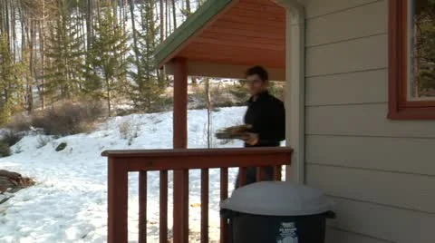Man puts cardboard in garbage can Stock Footage 21572833
