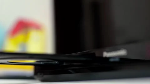 Man puts cd disc to a video player tray. Physical media concept.	 Stock Footage 301557073
