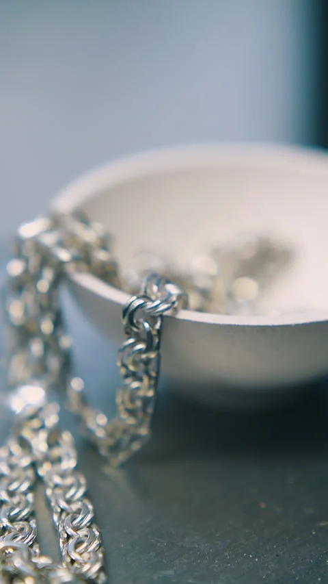 Man puts chain into bowl on scale in jewelry shop closeup Stock Footage 317083059