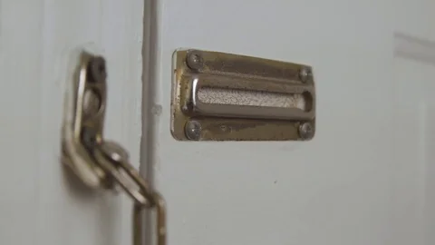 Man puts chain on door Stock Footage 76418629