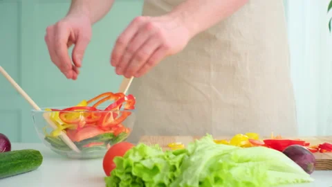Man puts chopped pepper in a plate Stock Footage 171911147