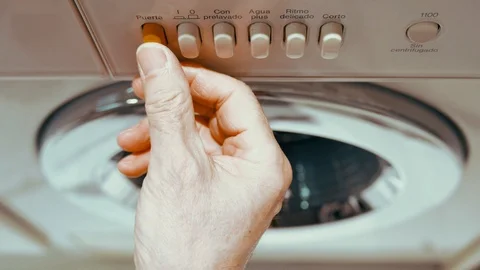 A man puts clothes in a washing machine 스톡 동영상 101388552