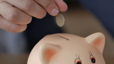 The Man Puts a Coin in the Piggy Bank 2 Stock Footage