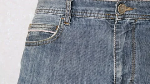 The man puts a condom in the front pocket of his jeans. Close-up Stock Footage 233277037