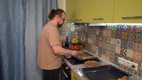 Man puts cookies from a baking sheet in bowl with a spatula. Homemade baking Stock Footage 313074672