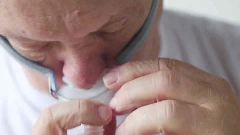 Man puts on a CPAP breathing device 스톡 동영상 90671977