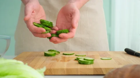 Man puts cucumbers in a plate Stock Footage 171910704