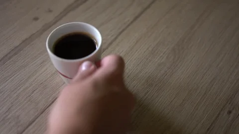 Man puts a cup of black coffe on a table. Top view 스톡 동영상 80129821