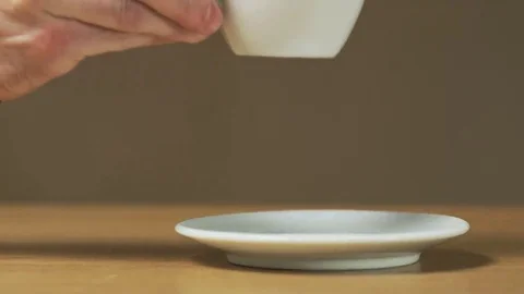A Man Puts a Cup on a Saucer Stock Footage 69159125