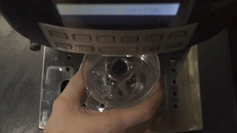 Man puts a cup under the coffee machine and selects a coffee drink Stock Footage 101660745