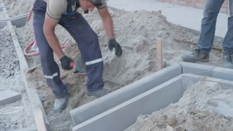 Man puts curbs on construction site 10.06.2020 Stock Footage 132491344