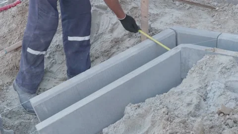 Man puts curbs on construction site 10.06.2020 Stock Footage 132491386