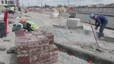 Man puts curbs on construction site 10.06.2020 Stock Footage 132493611