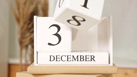 Man puts the date December 31 on the calendar. White block calendar present date Stock Footage 243792293