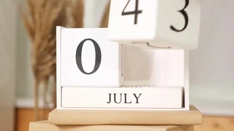 The man puts the date July 4th on the calendar. Wooden calendar with an Stock Footage 242298660