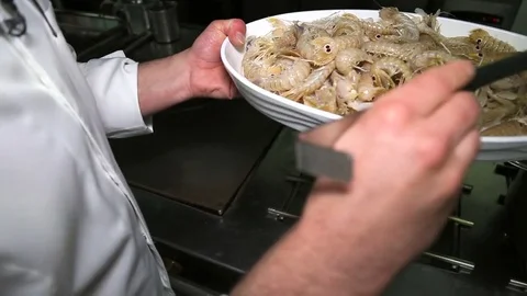 The man puts a different seafood in big saucepan. Close up Stock Footage 74523568