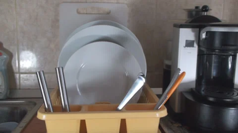 Man Puts Dishes In A Dish Stand Front Shot Stock Footage 36293798