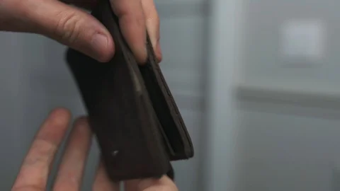 Man puts dollars in his wallet, closeup hands 動画素材 130026566