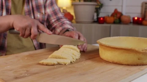 A man puts dough into a baking mold to make pumpkin pie Stock Footage 286097421