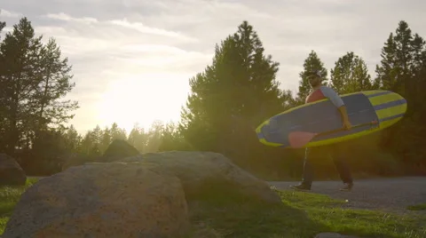 Man puts down his paddle board Stock Footage 62842125