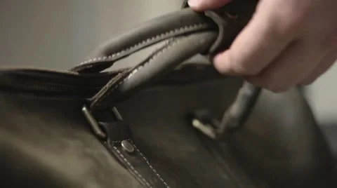 A man puts down his travel bag and looks inside - close shot Stock Footage 54527985