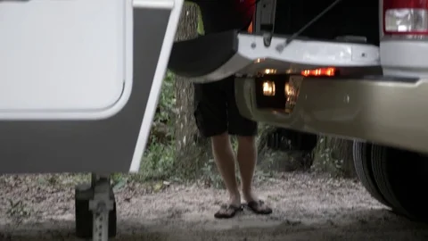 Man Puts Down Leveling System on Fifth Wheel RV Camper Stock Footage 80535296
