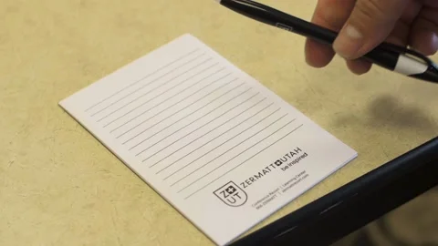 Man puts down a pen onto a notepad Video stock 136952825