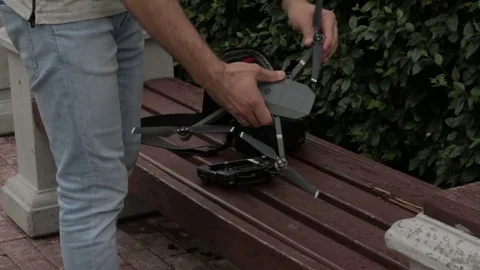 The man puts the drone in a bag Stock Footage 77627316