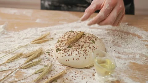 Man Puts An Ear Of Wheat On Raw Dough Stock Footage 273500800